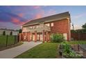 Spacious backyard showcasing a brick home with a balcony, complemented by a garden and ample green space at 9950 Foil Rd, Mount Pleasant, NC 28124
