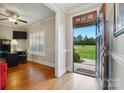 Inviting foyer featuring hardwood floors, and a view of the front yard, leading into a well-lit office space at 9950 Foil Rd, Mount Pleasant, NC 28124