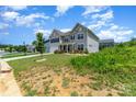 Charming two-story home boasts a manicured lawn, inviting entrance, and a two-car garage at 10045 Carousel Corral Dr, Midland, NC 28107