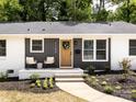 Inviting home exterior featuring a decorative front door wreath and cozy chairs on the front porch at 1152 Penrose Ln, Charlotte, NC 28217