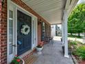 Inviting covered front porch with lovely wreath and outdoor seating at 121 Royalton Rd, Mooresville, NC 28115
