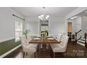 Formal dining room with hardwood floors, elegant chandelier, and stylish seating at 12923 Plumleaf Dr, Charlotte, NC 28213