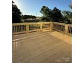 New wooden deck with railings overlooking a serene outdoor setting at 1308 Austin Chaney Rd, Wingate, NC 28174