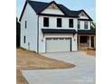 Charming two-story home with black roof, white siding, and attached garage at 1308 Austin Chaney Rd, Wingate, NC 28174
