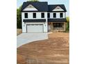 Charming two-story home with black roof, white siding, and attached garage at 1308 Austin Chaney Rd, Wingate, NC 28174