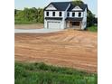 Charming two-story home with black roof, white siding, and attached garage at 1308 Austin Chaney Rd, Wingate, NC 28174