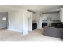 An unfinished kitchen featuring white upper cabinets, dark lower cabinets, and a center island at 1308 Austin Chaney Rd, Wingate, NC 28174