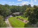 Sprawling property with lush greenery, mature trees, and a well-manicured lawn at 14415 Old Beatty Ford Rd, Gold Hill, NC 28071