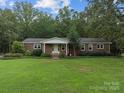 Classic brick home with a cozy front porch and a neatly kept, grassy lawn at 14415 Old Beatty Ford Rd, Gold Hill, NC 28071