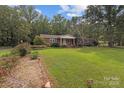 Traditional home featuring a large, green front lawn with lovely landscaping details at 14415 Old Beatty Ford Rd, Gold Hill, NC 28071