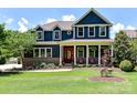 Charming two-story home featuring a welcoming front porch, brick accents, and a well-manicured lawn at 164 Twin Sisters Ln, Mooresville, NC 28117