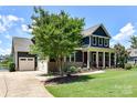 Beautifully maintained home with a spacious front yard, side entry garage and inviting front porch at 164 Twin Sisters Ln, Mooresville, NC 28117