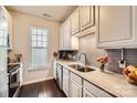 Well-lit kitchen featuring granite countertops, subway tile backsplash, and stainless steel appliances at 18605 Ruffner Dr # 3E, Cornelius, NC 28031