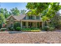 Charming home with stone accents, inviting front porch, lush landscaping, and manicured lawn at 258 Patterson'S Bridge None, New London, NC 28127