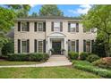 Stately two-story home featuring a well-maintained lawn, walkway, and symmetrically placed windows with black shutters at 2709 Wamath Dr, Charlotte, NC 28210