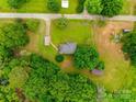 Overhead view of property showcasing the house, surrounding greenery, and layout of the land with driveway and outbuildings at 2921 Ambrose Dr, Gastonia, NC 28056