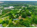Expansive aerial view of the property nestled among lush greenery, with the house located at 2921 Ambrose Dr at 2921 Ambrose Dr, Gastonia, NC 28056