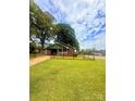 Quaint single-story brick home with a fenced yard and mature trees, creating a picturesque and inviting curb appeal on a spacious lot at 300 N Watterson St, Kings Mountain, NC 28086