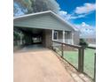 View of the covered carport and front entry, enhanced by a well-kept, fenced yard at 300 N Watterson St, Kings Mountain, NC 28086