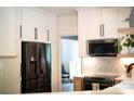 Modern kitchen featuring white cabinets, a black stainless steel refrigerator, and a subway tile backsplash at 3314 Mara Ct, Matthews, NC 28105