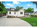 Quaint white home showcasing a well-manicured lawn, complementing the welcoming façade at 343 Melbourne Ct, Charlotte, NC 28209