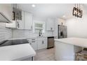 Stylish kitchen equipped with stainless steel appliances, white cabinets, and a functional island at 3615 Kempton Pl, Charlotte, NC 28208