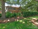 A well-maintained brick home is nestled among mature trees and manicured landscaping at 4026 Barclay Downs Dr, Charlotte, NC 28209
