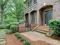Welcoming brick entrance featuring an arched porch and manicured shrubbery at 4026 Barclay Downs Dr, Charlotte, NC 28209
