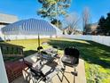 Outdoor patio area featuring a table, chairs, grill, and an umbrella for shade, perfect for outdoor dining at 435 Riverwalk Nw Dv, Concord, NC 28027