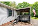 Close-up of front porch detailing a wood-finished surface and an American flag at 51 Emily Ln, Taylorsville, NC 28681