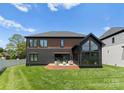 Expansive backyard featuring a lovely patio area, and well-maintained green grass at 5432 Carmel Rd, Charlotte, NC 28210