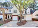 Inviting townhome featuring a brick-accented garage, manicured lawn, and welcoming curb appeal at 5953 Prescott Ct # 3105, Charlotte, NC 28269