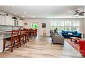 Spacious open-concept living room featuring modern light-colored vinyl floors and natural light at 6038 Durango Way, Denver, NC 28037