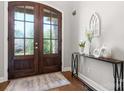 Elegant foyer with glass double doors, hardwood floors, and stylish decor at 73 41St Nw Ave, Hickory, NC 28601