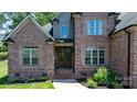 Inviting front entrance with double glass doors and brick steps at 73 41St Nw Ave, Hickory, NC 28601