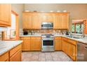 Well-equipped kitchen with stainless steel appliances, wooden cabinets, tile backsplash, and lots of counter space at 7545 Rabbit Cir, Denver, NC 28037