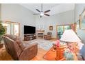 Inviting living room with a cozy fireplace, vaulted ceilings, hardwood floors, and a large ceiling fan at 7545 Rabbit Cir, Denver, NC 28037