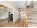 Inviting foyer with wood floors, staircase, and access to a bright office space at 7642 Rolling Meadows Ln, Huntersville, NC 28078