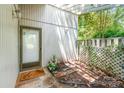 Inviting entryway with a shaded porch, charming decor, and a welcoming doormat, creating a warm entrance at 7900 Horse Chestnut Ln, Charlotte, NC 28277