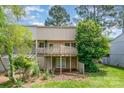 Two-story home showcasing a spacious deck, walkout basement, and a lush green backyard at 7928 Horse Chestnut Ln, Charlotte, NC 28277