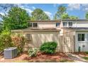 Charming townhome featuring a fenced entryway, lush landscaping, and a well-maintained lawn at 7928 Horse Chestnut Ln, Charlotte, NC 28277