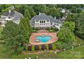 Aerial view of estate home with a large in-ground pool and meticulously landscaped grounds at 8800 Covey Rise Ct, Charlotte, NC 28226