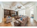 Spacious living room with coffered ceilings, fireplace with built-ins, and hardwood floors at 9202 Arlington Hills Dr, Mint Hill, NC 28227