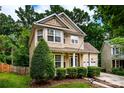 Well-maintained two-story home featuring a lush green lawn and mature trees at 9410 Greenbank Ct, Charlotte, NC 28214