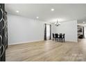 Spacious dining area with modern flooring, chandelier, and a full view of the adjacent living spaces at 1005 Exodus Ct, Monroe, NC 28110