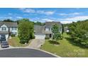 Aerial view of a home, showcasing its landscaping, driveway, and neighborhood at 1111 Balcorn Pl, Charlotte, NC 28214