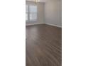 Bright living room featuring hardwood floors and natural light from the window at 1111 Balcorn Pl, Charlotte, NC 28214