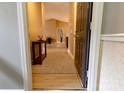 Welcoming hallway featuring light, wood-look floors and a neutral color palette, creating a warm entry at 11867 Ridgeway Park Dr, Charlotte, NC 28277