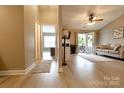Spacious living room with wood-look floors, neutral walls, ceiling fan, and access to an outdoor area at 11867 Ridgeway Park Dr, Charlotte, NC 28277
