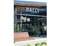 Modern restaurant exterior with 'RALLY' sign, large windows, and inviting outdoor seating at 121 Verbena Ne St # 14, Charlotte, NC 28217